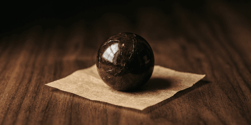 A temple ball is a sphere of pressed, aged hash with roots in Nepal, India, and Afghanistan. Learn how they're made, what separates good ones from bad, and why they've become a benchmark in solventless cannabis.