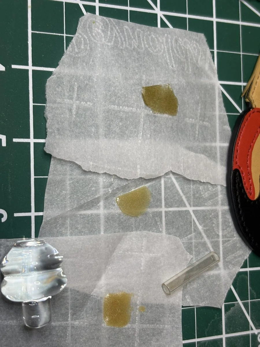 Three pressed flags on parchment: PUA at top, Wooksauce in the middle and 710 at bottom