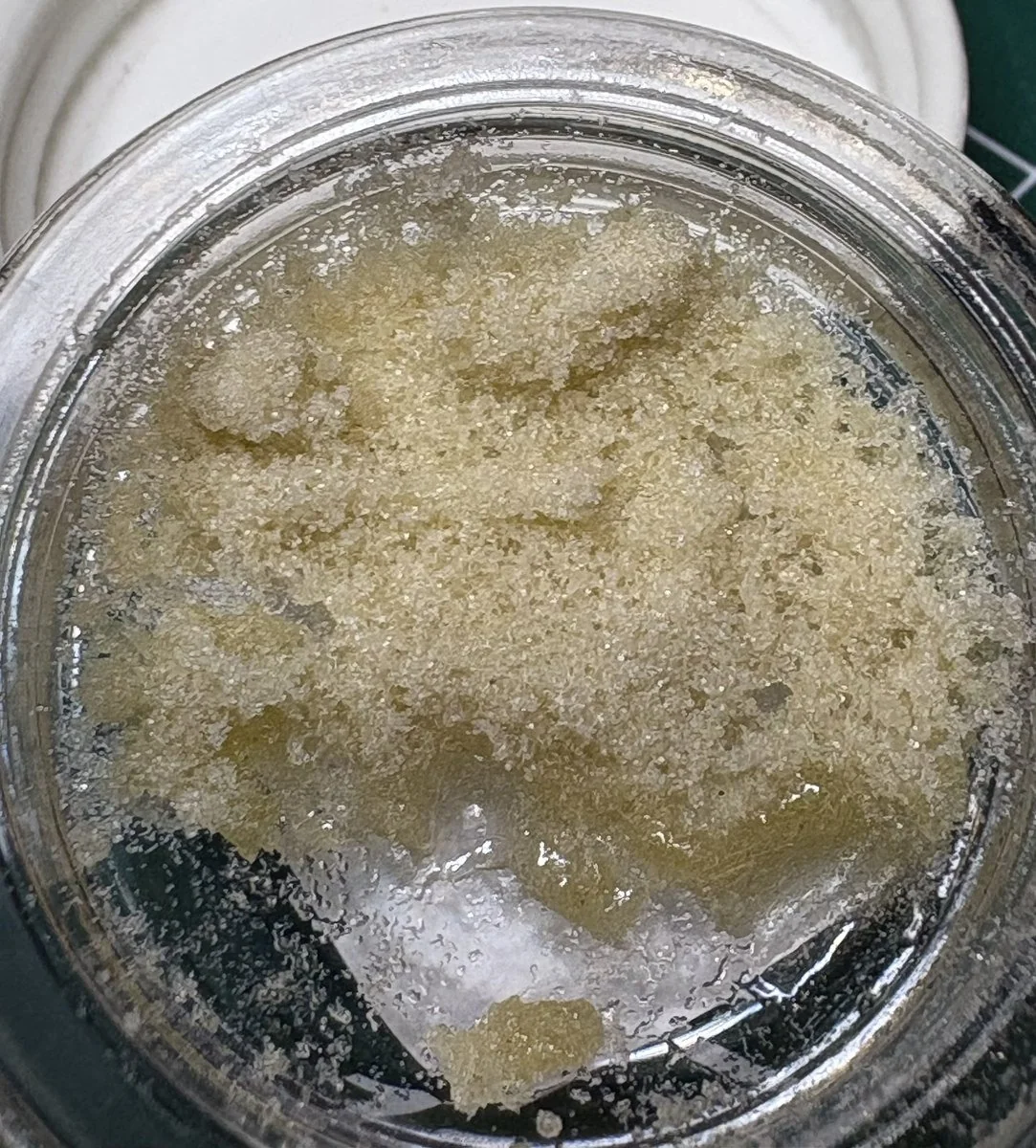 Close-up of an open Wooksauce jar, showing the original resin texture and color