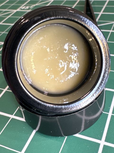 The open jar from above: pale, creamy rosin