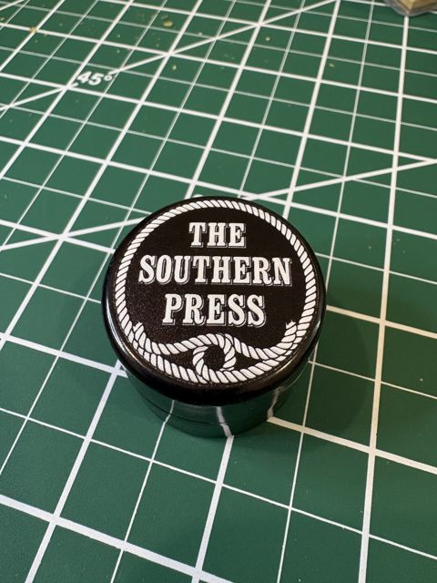 The Southern Press lid: the brand name in a rope border
