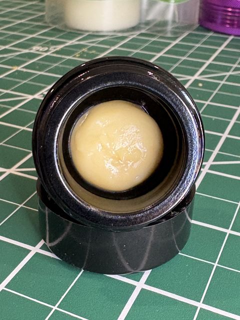 The open Mangosteen jar from the front: pale, creamy rosin