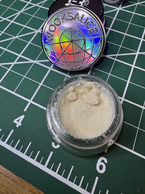 The jar beside the holographic Wooksauce lid on a green cutting mat